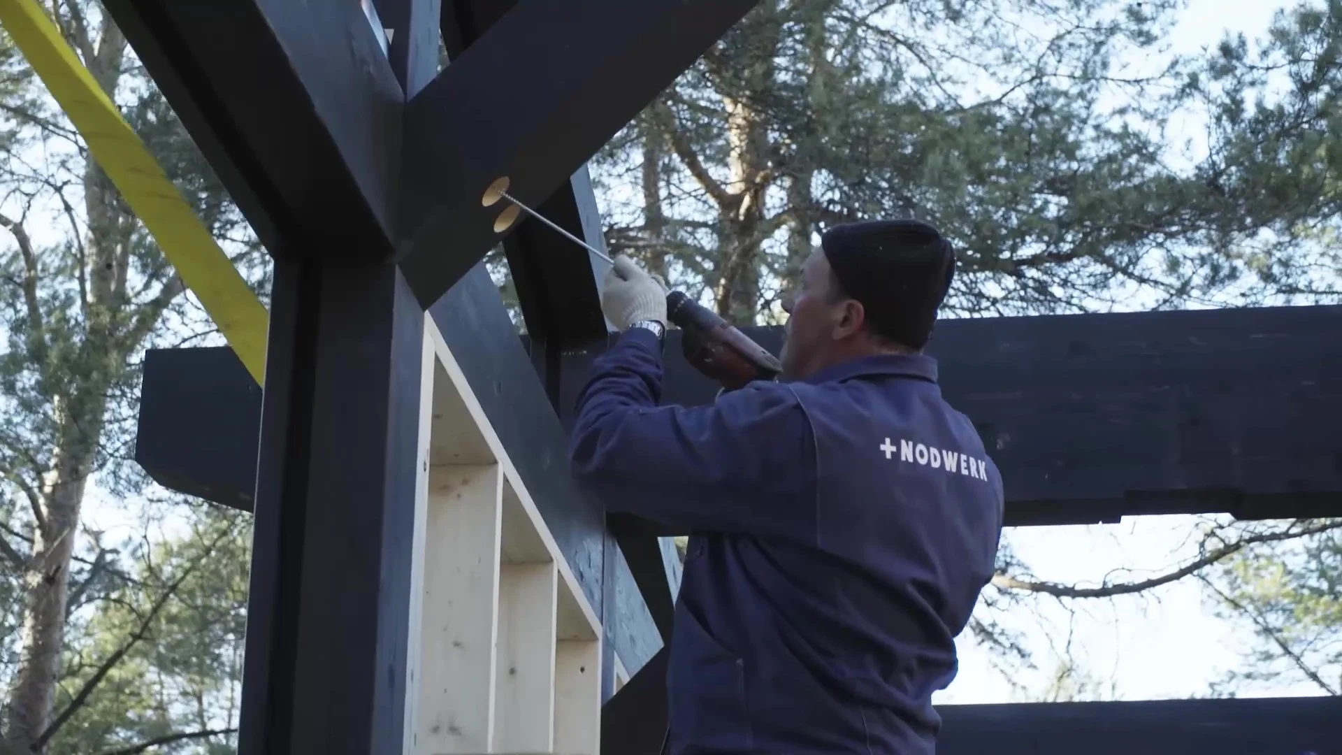 Worker assembling a timber structure
